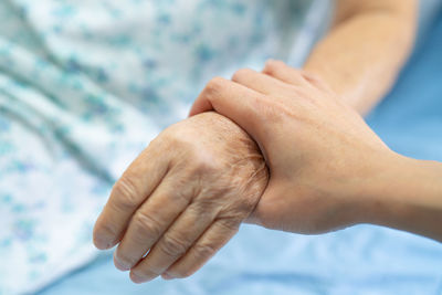 Cropped image of couple holding hands