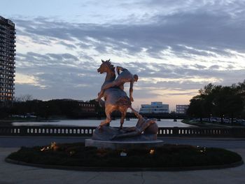 Statue of dog at sunset