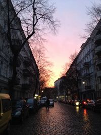 Cars parked on road at sunset