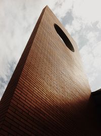 Low angle view of building against cloudy sky