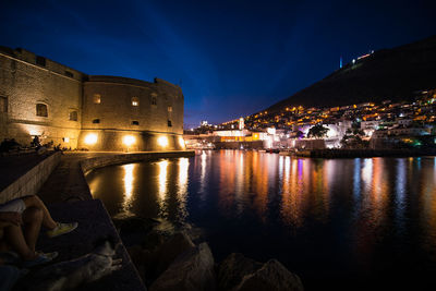 Reflection of illuminated buildings in lake at night