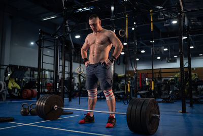 Muscular bodybuilder preparing for exercise