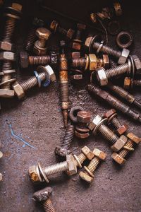 High angle view of old nut and bolts on floor