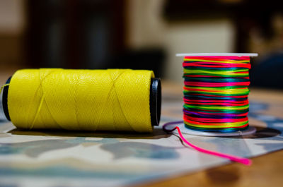 Close-up of thread spools on table