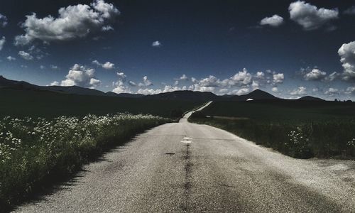 Road amidst landscape against sky