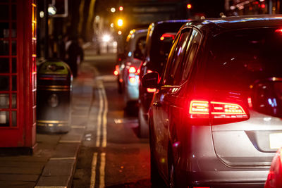 Vehicles on road in city at night