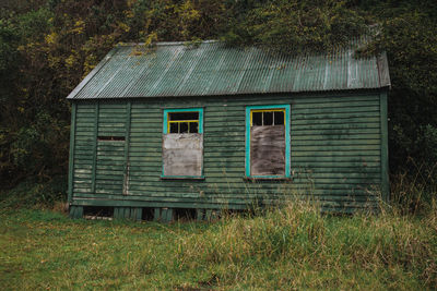 Old abandoned house on field