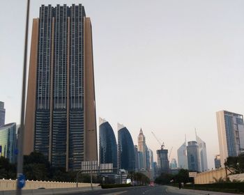 Modern buildings in city against clear sky