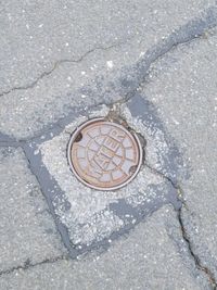 High angle view of manhole on street