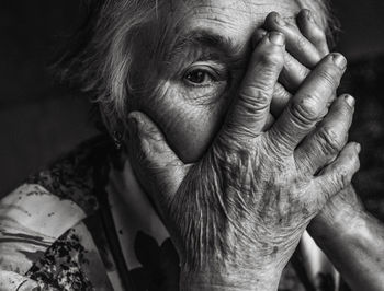 Close-up portrait of woman with hands