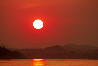 Scenic view of sea against orange sky during sunset