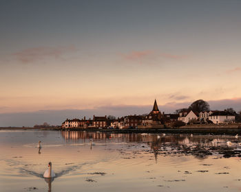 Bosham quay at sunrise with swans 