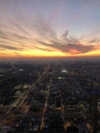 High angle view of buildings in city during sunset