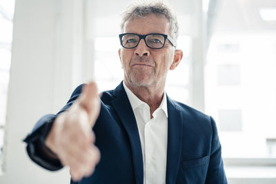 Businessman offering handshake at work place