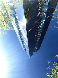 Low angle view of icicles against blue sky