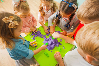 High angle view of kids playing with powder paint