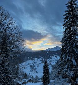 Scenic view of snowcapped mountains against sky during sunset