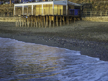 Wet beach by bridge