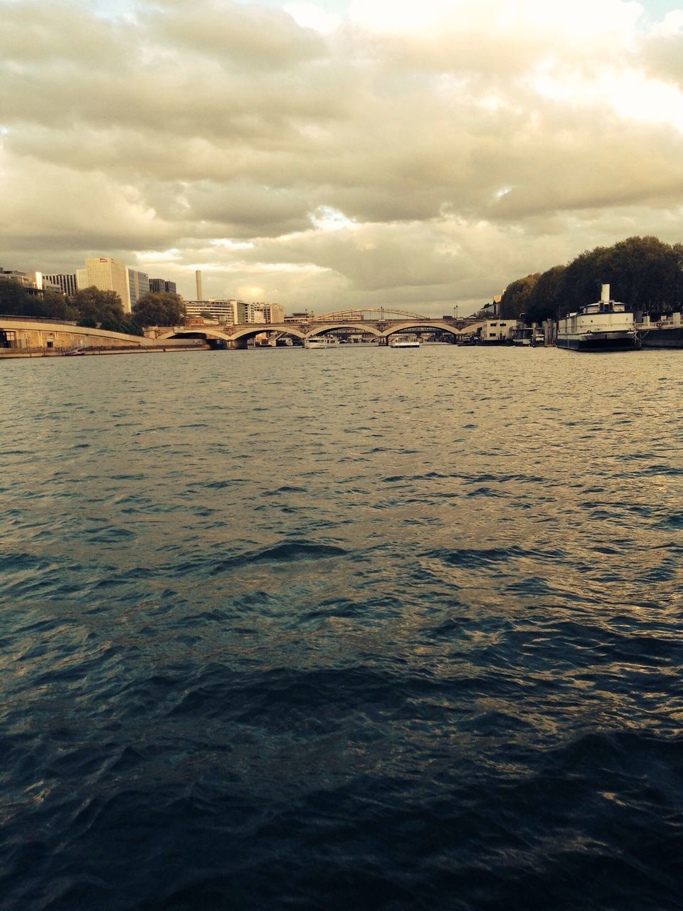 water, sky, sea, cloud - sky, waterfront, building exterior, architecture, built structure, cloudy, rippled, city, cloud, sunset, scenics, nature, beach, wave, beauty in nature, tranquil scene, river