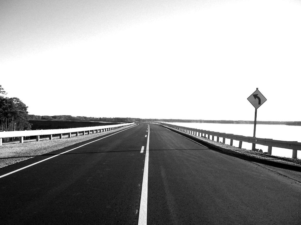 the way forward, diminishing perspective, vanishing point, transportation, clear sky, road marking, road, copy space, empty, long, asphalt, street light, empty road, sky, surface level, connection, outdoors, day, railing, country road