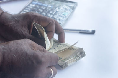 Close-up of a hand holding paper