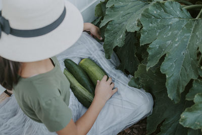 High angle view of woman holding plant