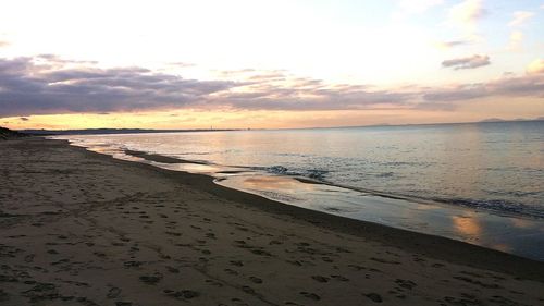 Scenic view of beach against sky during sunset