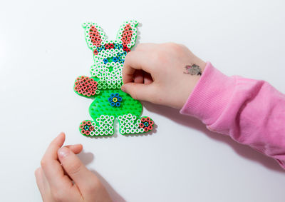 Close-up of baby hand against white background