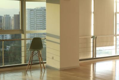 Empty chairs and table against window at home