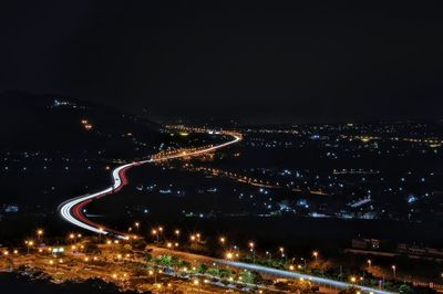 Aerial view of illuminated city against sky at night
