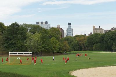 People playing soccer in park