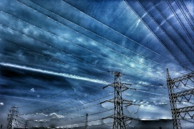 Low angle view of power lines against sky