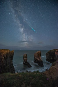 Scenic view of landscape against sky at night