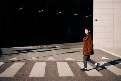 Portrait of woman crossing road