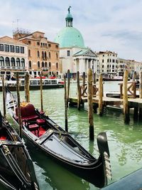 Boats in canal against buildings in city