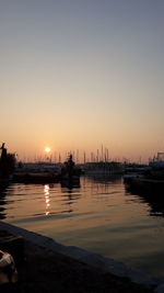 Sailboats in marina at sunset