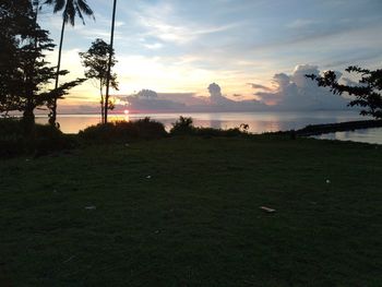 Scenic view of field against sky during sunset