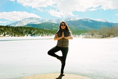Portrait of a young woman standing on mountain