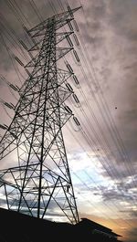 Low angle view of electricity pylon against sky