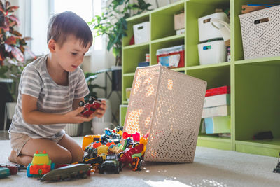 High angle view of boy using digital tablet while sitting at home