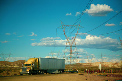 A truck parked in front of pylon in the desert of nevada