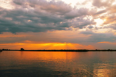 Scenic view of lake against sky during sunset
