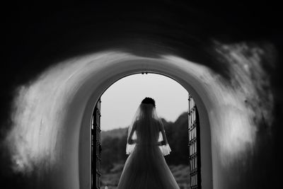 Woman standing in corridor