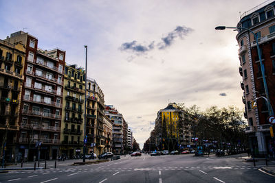 City street by buildings against sky