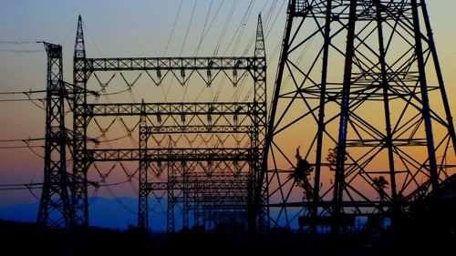 Low angle view of electricity pylon against sky