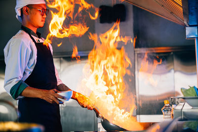 Midsection of man preparing food in kitchen