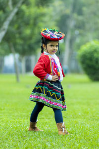 Full length of cute girl standing on grass