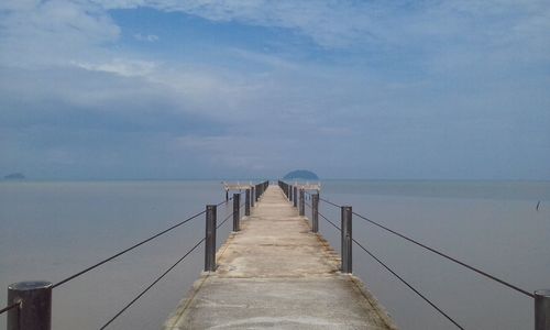 Pier over sea against sky