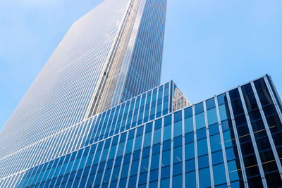 Low angle view of modern building against clear blue sky
