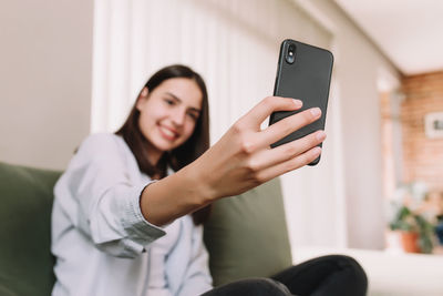 Midsection of woman using mobile phone